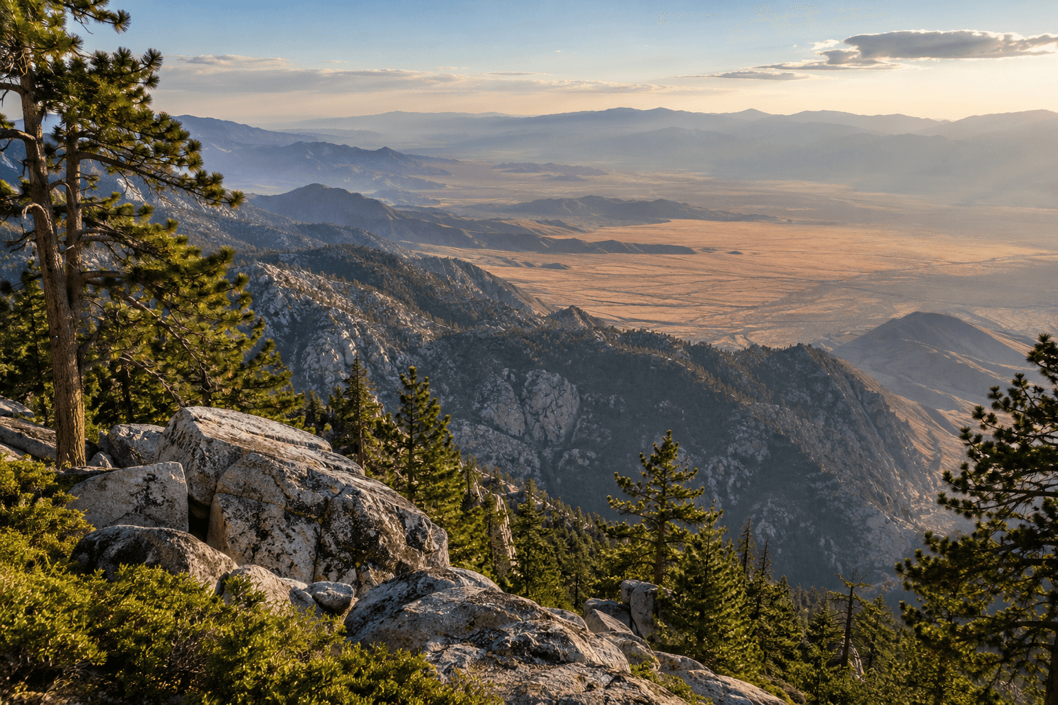 Pines and granite overlook a hazy desert basin from an imagined mountain lookout.